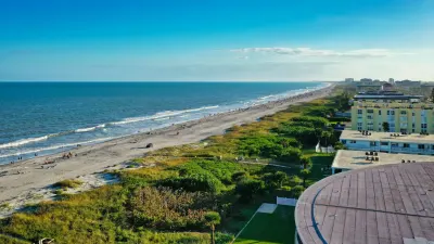 Aerial view of Cocoa Beach with sandy shoreline, hotels, and Atlantic Ocean waves