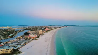 Aerial view of St Pete Beach with white sand, turquoise water, and beachfront hotels
