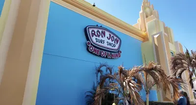 Ron Jon Surf Shop storefront with blue wall and neon signage
